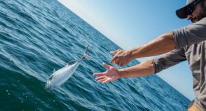 Guy Throwing Fish Back